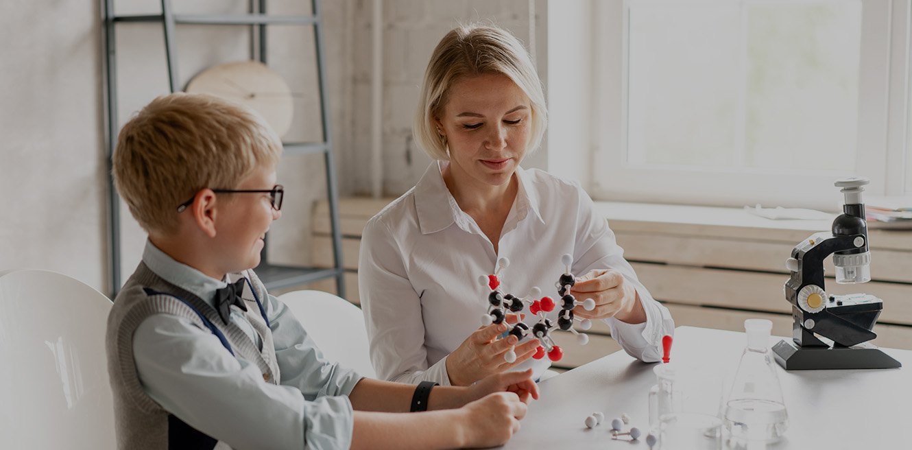 Female science tutor in Fremont studying chemistry with student